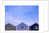 Beach huts in a row against sky by Assaf Frank